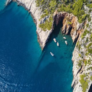 Where red cliffs meet turquoise water, your private boat is the...